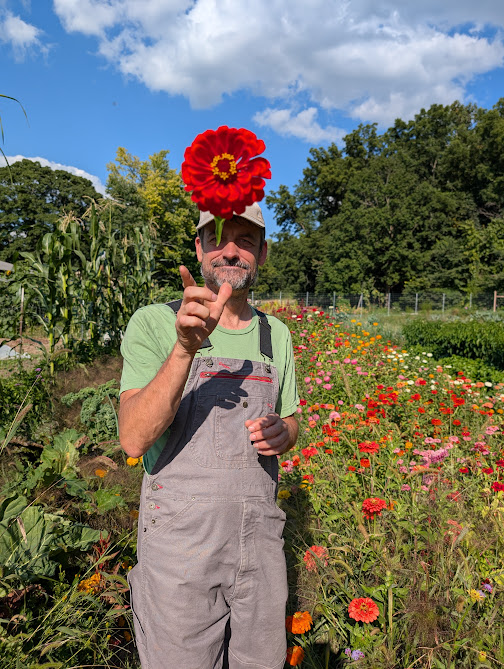 Sam in the garden among the flowers