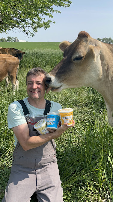 Sam sharing a quiet moment with a curious cow