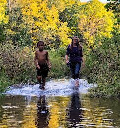 Shawna and a companion crossing a creek